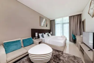 a hotel room with a bed and a couch at Modern Studio in Seven Palm in Dubai
