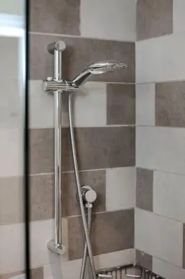 a shower in a bathroom with a shower head at Modern Studio in Seven Palm in Dubai