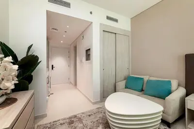 a living room with a couch and a chair at Modern Studio in Seven Palm in Dubai