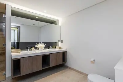 a bathroom with a sink and a mirror at Burj Khalifa View 3bedroom in Dubai