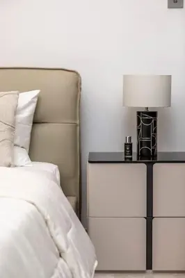 a bedroom with a bed and a lamp on a nightstand at Burj Khalifa View 3bedroom in Dubai