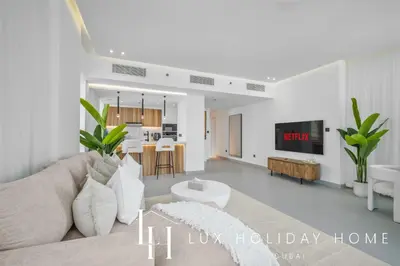 a living room with a couch and a table at LUX The Majara Marina View Suite in Dubai