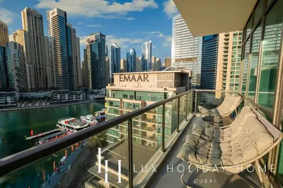 a balcony with a view of a city at LUX The Majara Marina View Suite in Dubai
