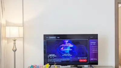 a flat screen tv sitting on a table next to a lamp at Fully Furnished 1BR In Montrose Tower B Dubai, Close by Dubai Science Park, Dubai Miracle Garden, Dubai Hills Mall in Dubai