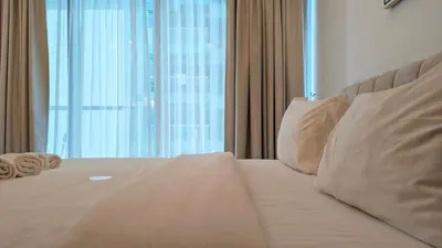 a bed in a room with a large window at Fully Furnished 1BR In Montrose Tower B Dubai, Close by Dubai Science Park, Dubai Miracle Garden, Dubai Hills Mall in Dubai