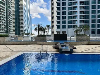 a large swimming pool in a city with tall buildings at Skyline Sanctuary on the 82nd in Dubai