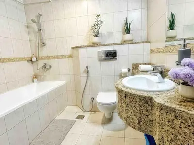 a bathroom with a sink and a toilet and a bath tub at Skyline Sanctuary on the 82nd in Dubai