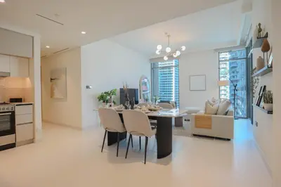 a kitchen and dining room with a table and chairs at HiGuests - Elegant 2-Bedroom Retreat at Marina Vista 2 in Dubai