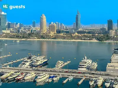 a group of boats docked in a harbor with a city at HiGuests - Elegant 2-Bedroom Retreat at Marina Vista 2 in Dubai