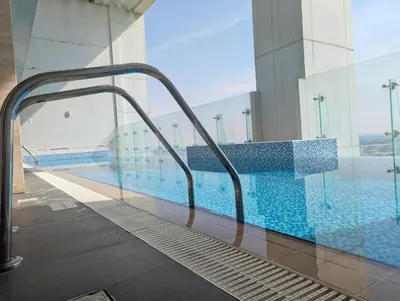 a swimming pool on top of a building at Fully Furnished 1BR Close by Dubai Science Park, Dubai Miracle Garden, Dubai Hills Mall in Dubai