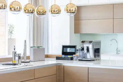 a kitchen with a counter with a microwave and appliances at Ultra-Luxury 6BR Palm Villa - Private Pool & Beach in Dubai