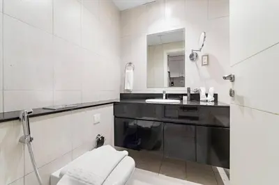 a white bathroom with a sink and a toilet at FIRST CLASS Studio Luxury Getaway in Dubai