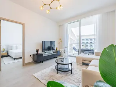 a living room with a couch and a tv at Modern Spacious- 2 BR with Pool & Gym- Luma 22 JVC in Dubai