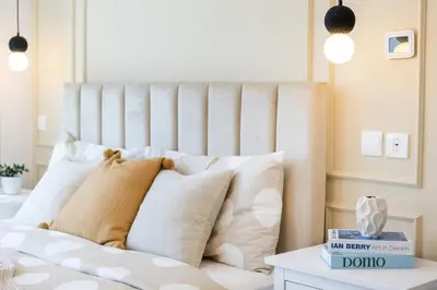 a white bed with white pillows and a white table at Spacious 3 BR Newly Furnished - Dubai Marina in Dubai