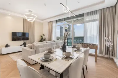 a living room with a table and a couch at Spacious 3 BR Newly Furnished - Dubai Marina in Dubai