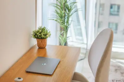 a wooden table with a laptop on top of it at Spacious 3 BR Newly Furnished - Dubai Marina in Dubai