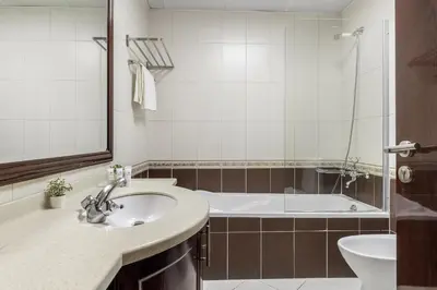 a bathroom with a sink and a tub at Spacious 3 BR Newly Furnished - Dubai Marina in Dubai