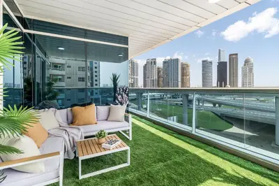 a living room with a couch on a balcony at Spacious 3 BR Newly Furnished - Dubai Marina in Dubai