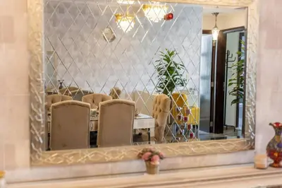a mirror on a wall with chairs and a dog at Royal King Size Stay 2BR With Marina View in Dubai