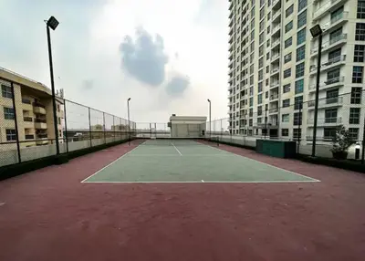 a tennis court in the middle of two tall buildings at Royal King Size Stay 2BR With Marina View in Dubai