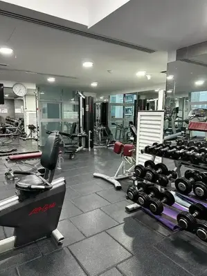a gym with a bunch of equipment in a room at Royal King Size Stay 2BR With Marina View in Dubai