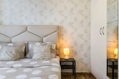 a bedroom with a white bed with two pillows at Royal King Size Stay 2BR With Marina View in Dubai