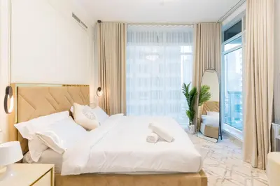a bedroom with a white bed and a large window at Luxury 3BR with Stunning Full Marina View in Dubai in Dubai