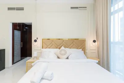 a bedroom with a large white bed with white pillows at Luxury 3BR with Stunning Full Marina View in Dubai in Dubai