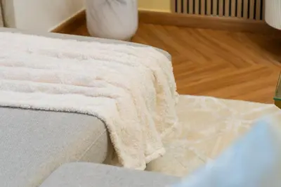 a blanket sitting on the edge of a couch at Luxury 3BR with Stunning Full Marina View in Dubai in Dubai