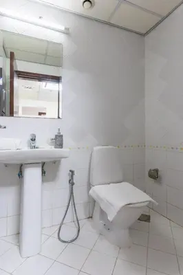 a white bathroom with a toilet and a sink at Luxury 3BR with Stunning Full Marina View in Dubai in Dubai