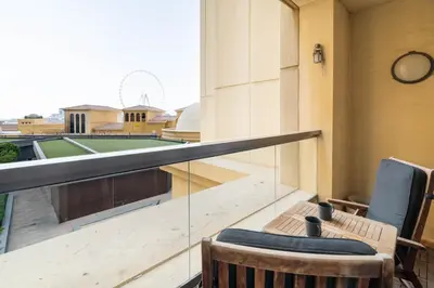 a balcony with two chairs and a clock on a building at GuestReady - Serene retreat with Ain Dubai Views in Dubai