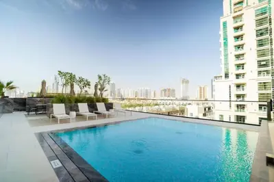 a large swimming pool on top of a building at Beautiful 1BR - City View - Pool - Free Parking in Dubai