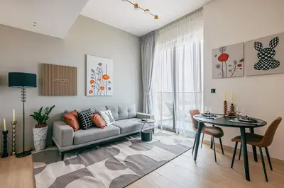 a living room with a couch and a table at Beautiful 1BR - City View - Pool - Free Parking in Dubai