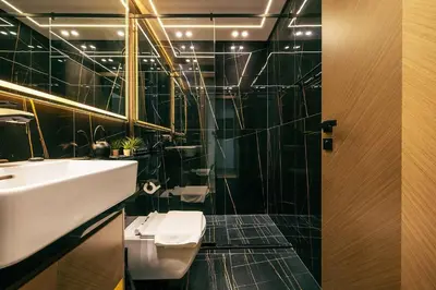 a bathroom with a sink and a toilet and a mirror at Beautiful 1BR - City View - Pool - Free Parking in Dubai