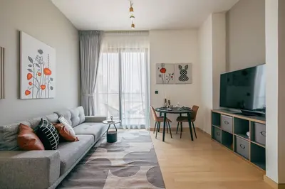 a living room with a couch and a table at Beautiful 1BR - City View - Pool - Free Parking in Dubai