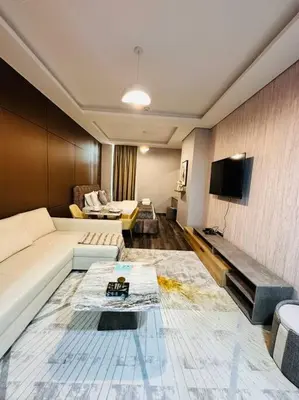 a living room with a couch and a tv at Airvistas CityNest Retreat at Business Bay, Dubai in Dubai
