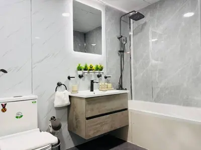 a bathroom with a sink and a shower and a toilet at Airvistas CityNest Retreat at Business Bay, Dubai in Dubai