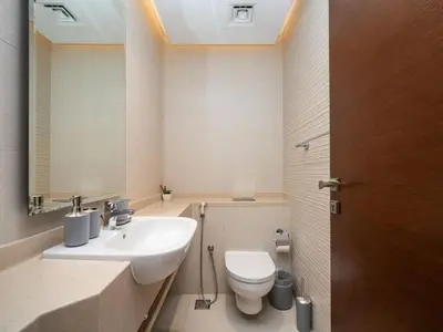 a bathroom with a sink and a toilet at Chic 1 Bed Getaway in Al Jaddaf Easy City Access in Dubai