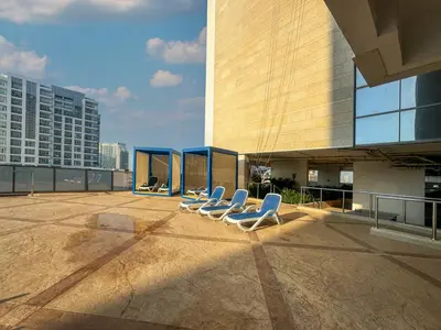 a group of chairs sitting on the roof of a building at Chic 1 Bed Getaway in Al Jaddaf Easy City Access in Dubai
