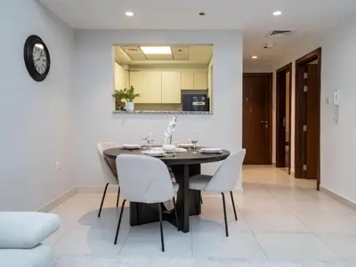 a dining room with a table and chairs at Chic 1 Bed Getaway in Al Jaddaf Easy City Access in Dubai
