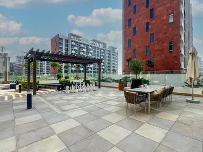 a rooftop patio with a table and chairs and a pavilion at Elegant Studio in Azizi Riviera, Meydan in Dubai