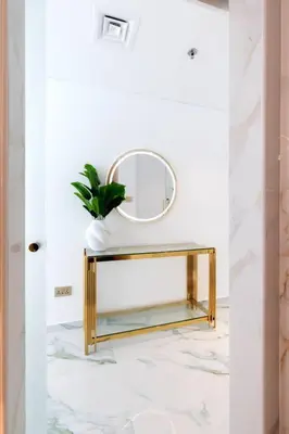 a bathroom with a mirror and a table with a plant at Lux apartments x Dubai studio 22 in Dubai