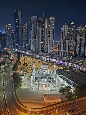a building in front of a city at night at Lux apartments x Dubai studio 22 in Dubai