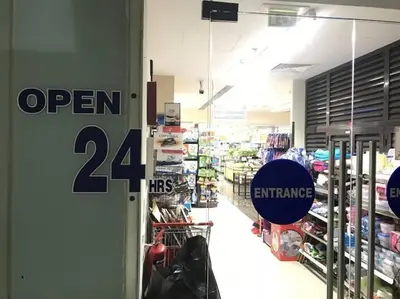 a store with a open hrs sign on the door at Lux apartments x Dubai studio 22 in Dubai