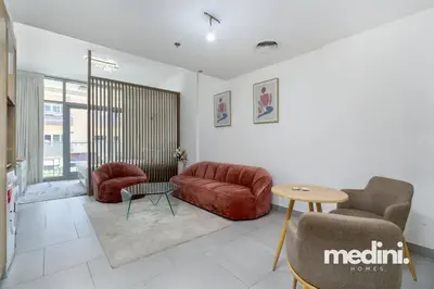 a living room with a couch and chairs and a table at Large studio in JVC - Dubai in Dubai