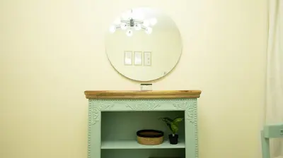 a mirror on top of a fireplace in a room at Modern Apartment near Burj khalifa in Dubai