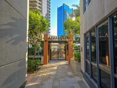 an entrance to a building with a gate and trees at EasyGo- amazing 1bdr with view south ridge- downtown in Dubai
