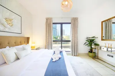a bedroom with a bed with a stuffed animal on it at Elegant 2BR Apartment in Yansoon 3 with Burj Khalifa Views in Dubai