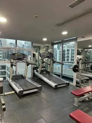 a gym with several tread machines in a building at Stunning Newly Furnished Apartment Dubai Marina in Dubai