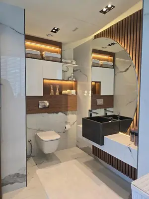 a bathroom with a sink and a toilet and a mirror at Beachfront 250 view private beach high floor in Dubai